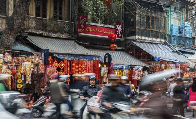 Busy traffic and old buildings in Hanoi's Old Quarter